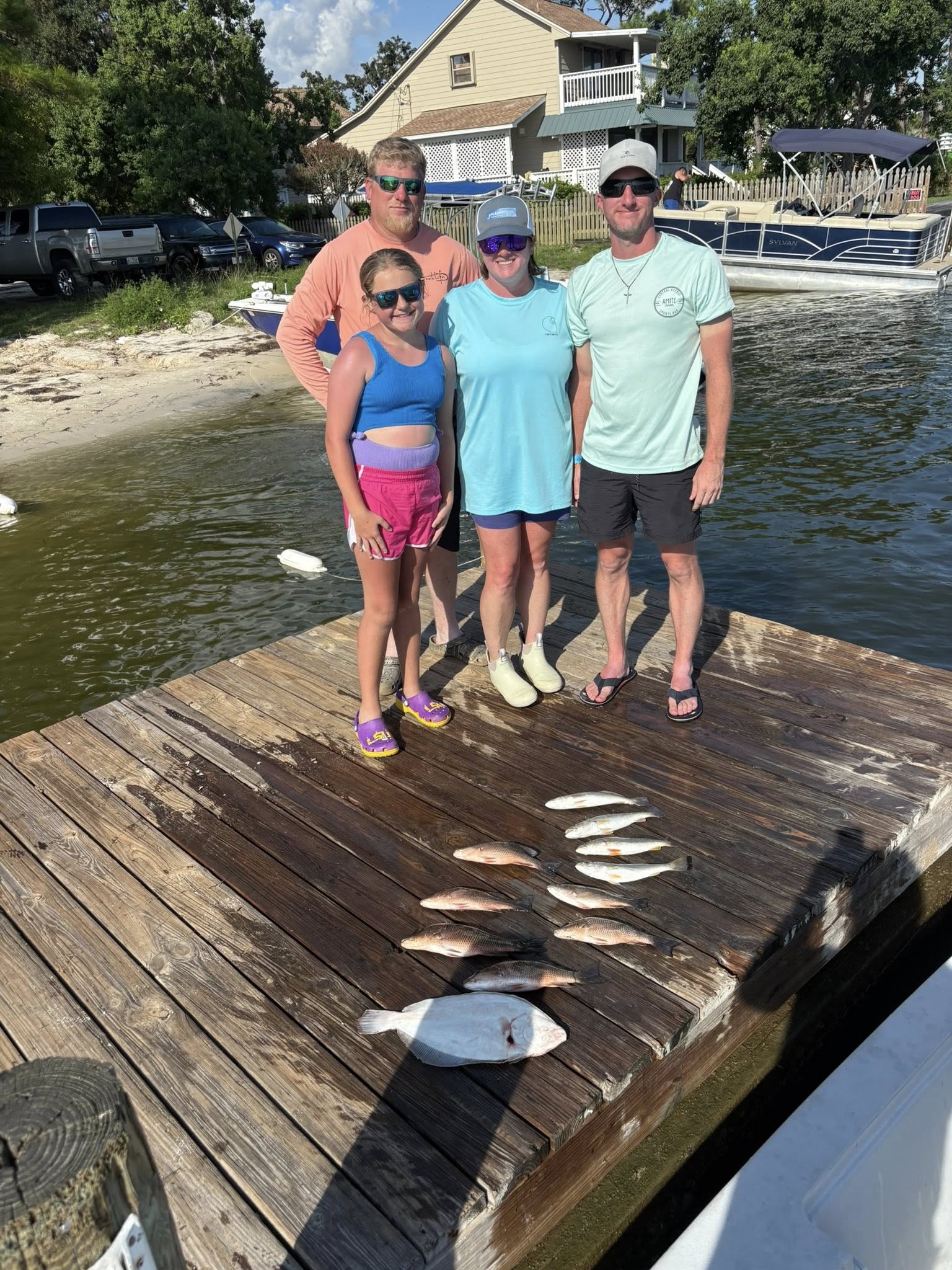Fresh caught fish displayed on wooden dock in Pensacola FL after successful fishing trip