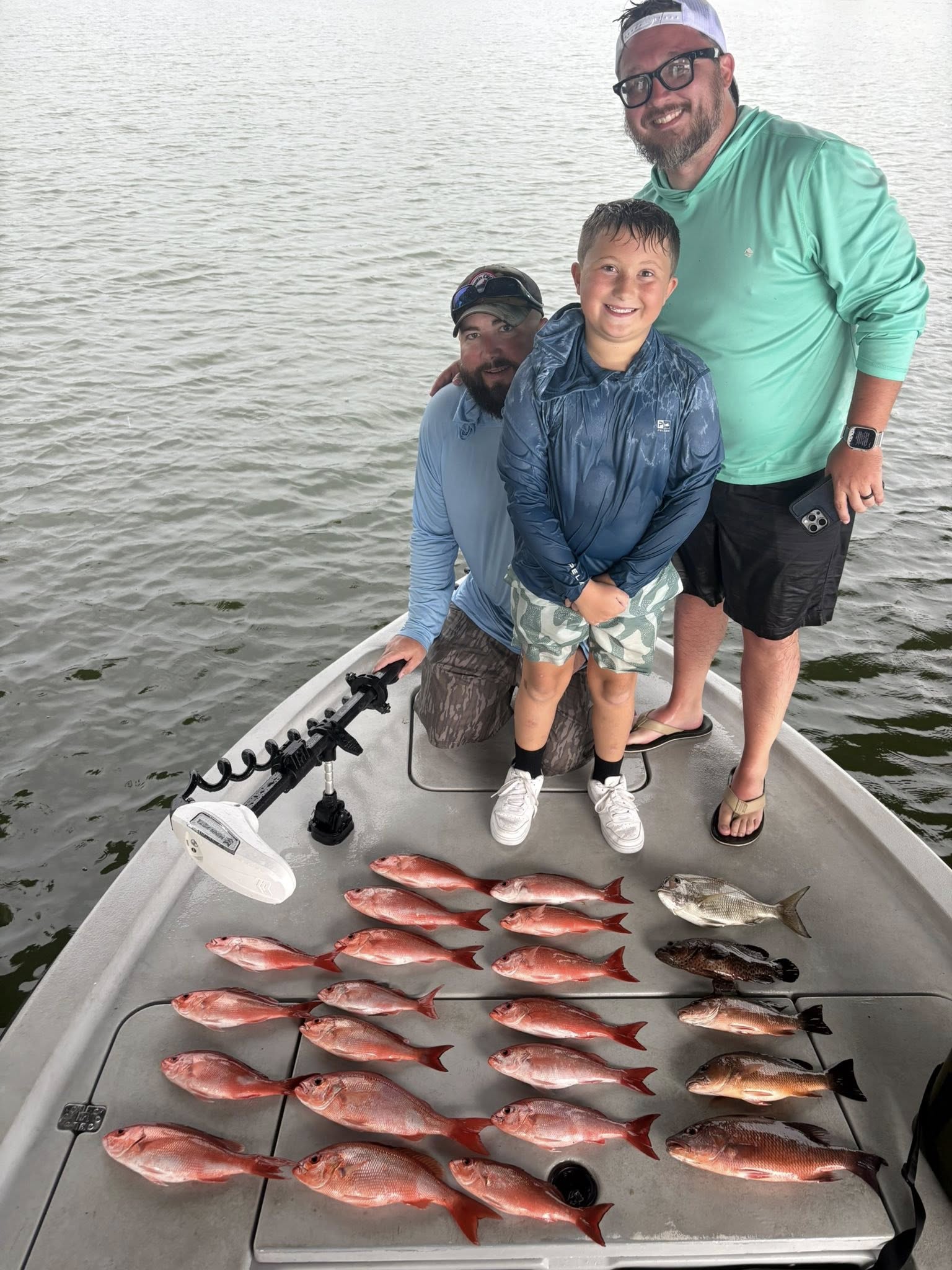 Successful fishing trip in Pensacola FL showing fresh caught red snapper laid out on boat deck