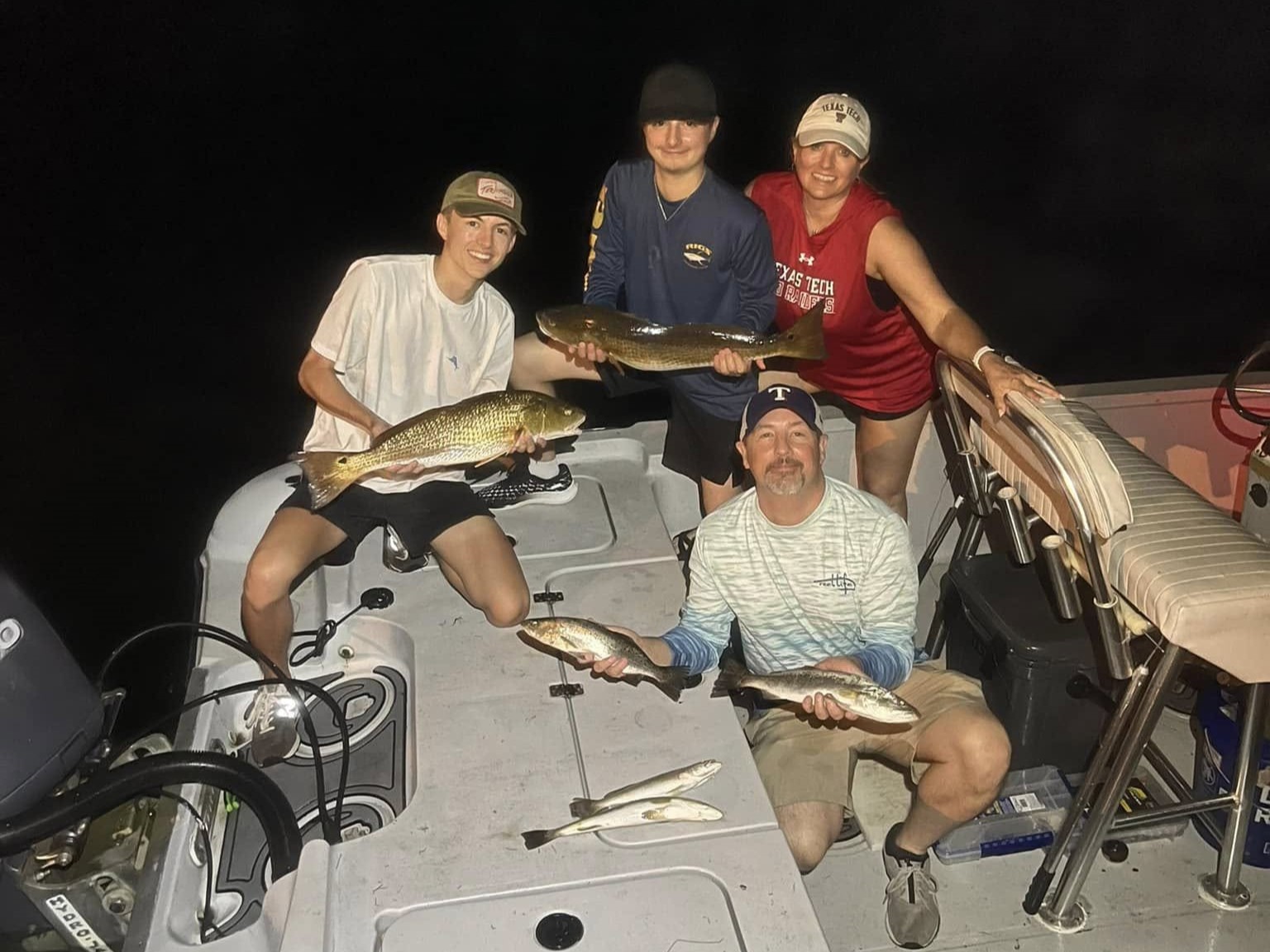 Pensacola night fishing trip targeting redfish and trout around dock lights and bridges