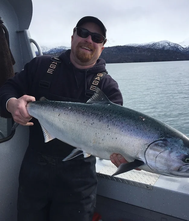 Angler catches a large rainbow trout in Homer, Alaska