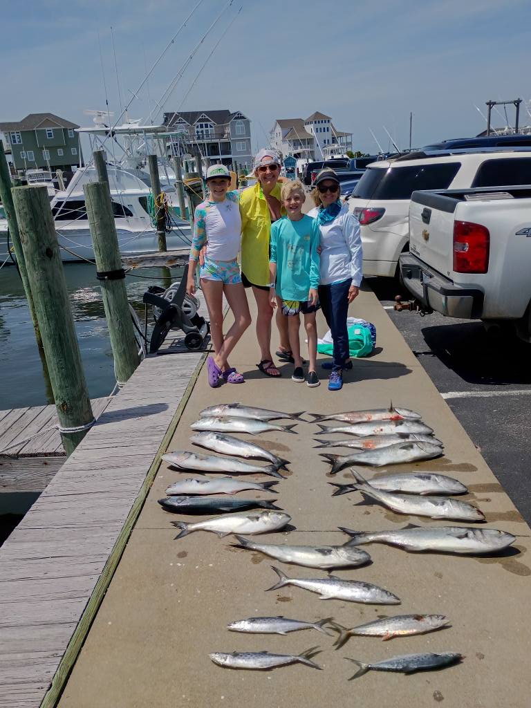 Successful fishing trip in Frisco NC showing multiple King Mackerel and Bluefish laid out on dock