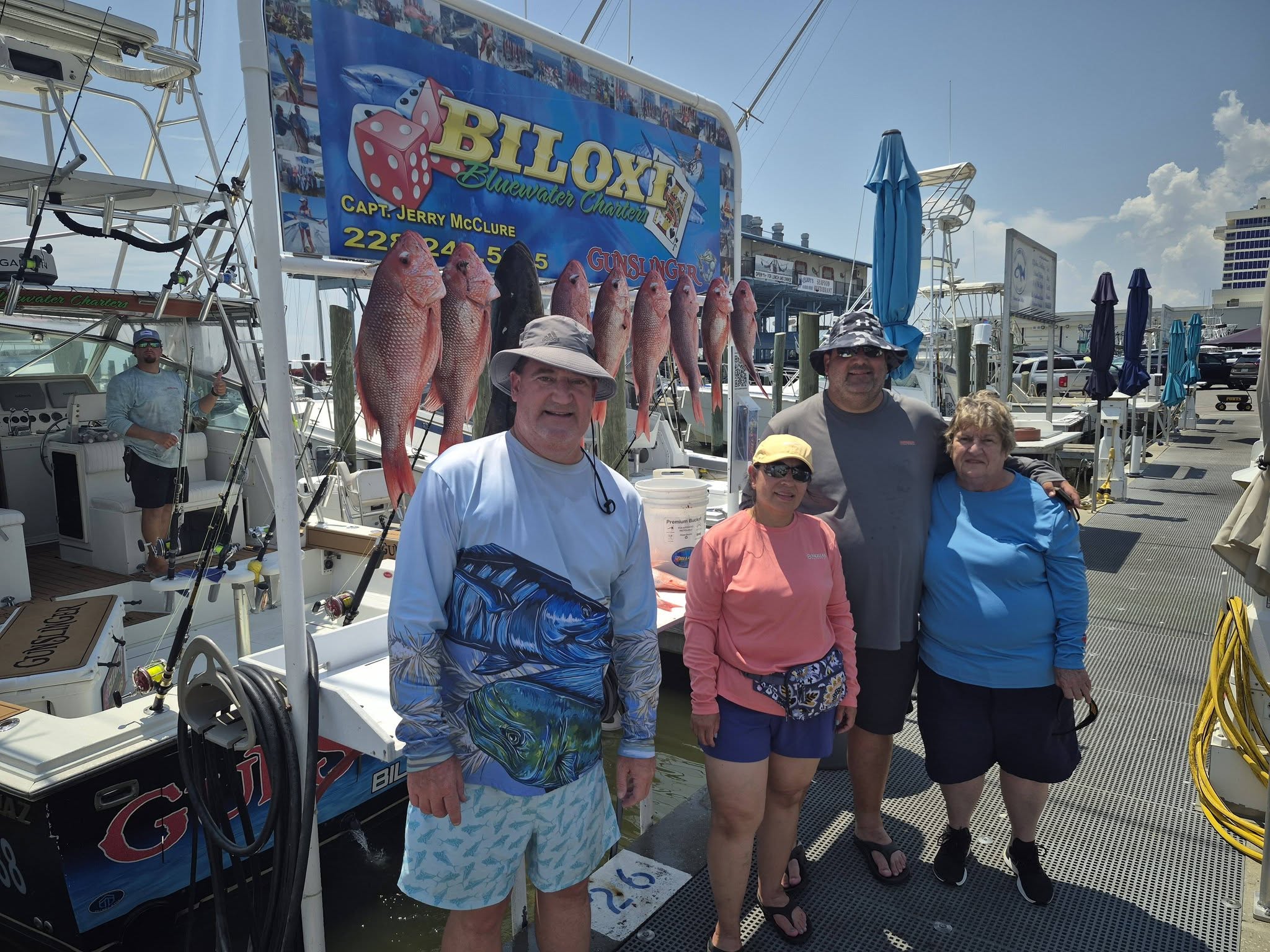 Red snapper fishing charter catch displayed on dock in Biloxi MS with multiple fish hanging