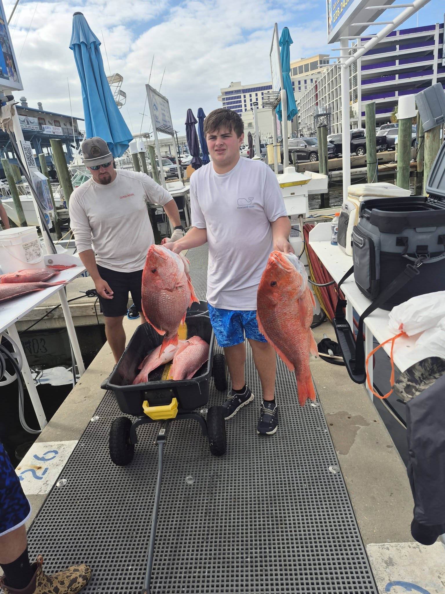 Red snapper fishing success in Biloxi MS with large catch displayed on boat dock