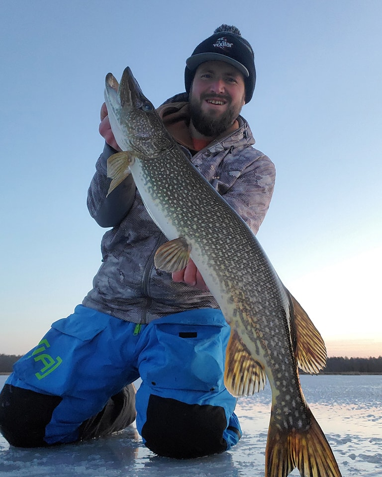 Angler with large Northern Pike fish catch in Minnesota