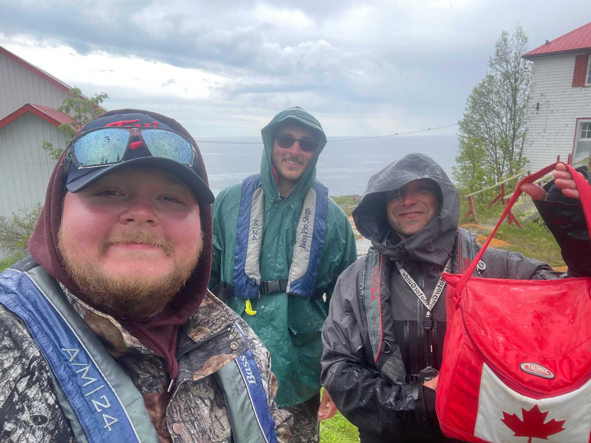 Fishing guides and guests in rain gear during a fishing tour in Nipigon ON