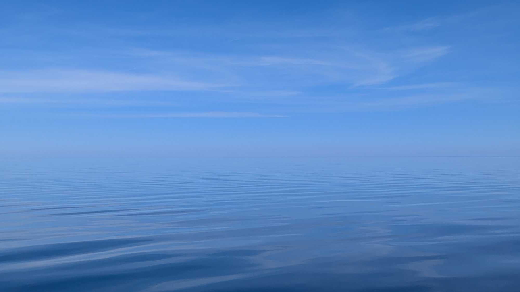 Calm blue waters under clear sky in Nipigon Ontario perfect for fishing tours