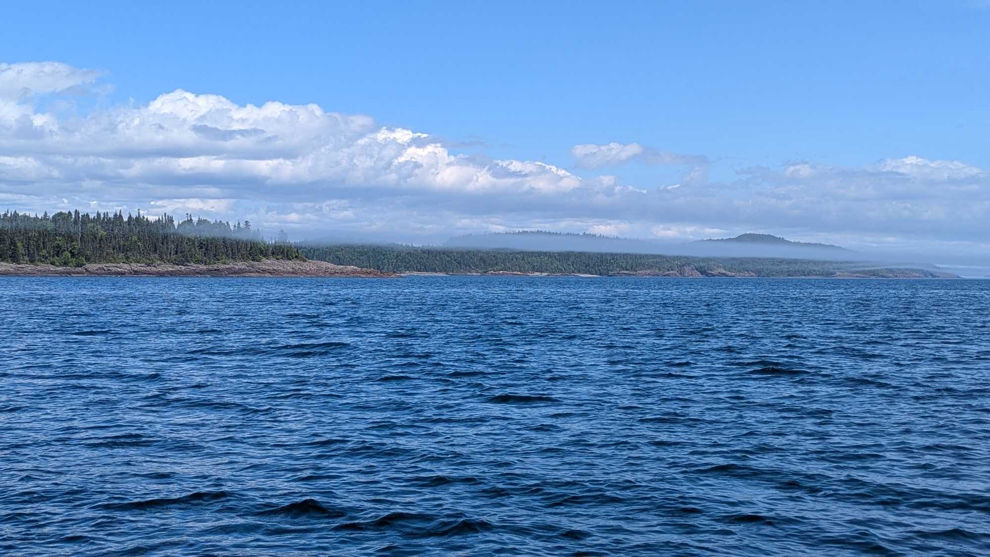 Deep blue waters with forested shoreline near Nipigon ON, perfect for fishing tours