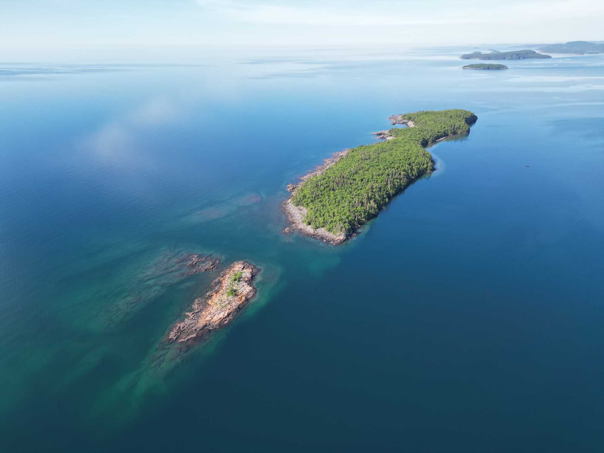 Aerial view of forested islands in blue waters near Nipigon Ontario fishing destination