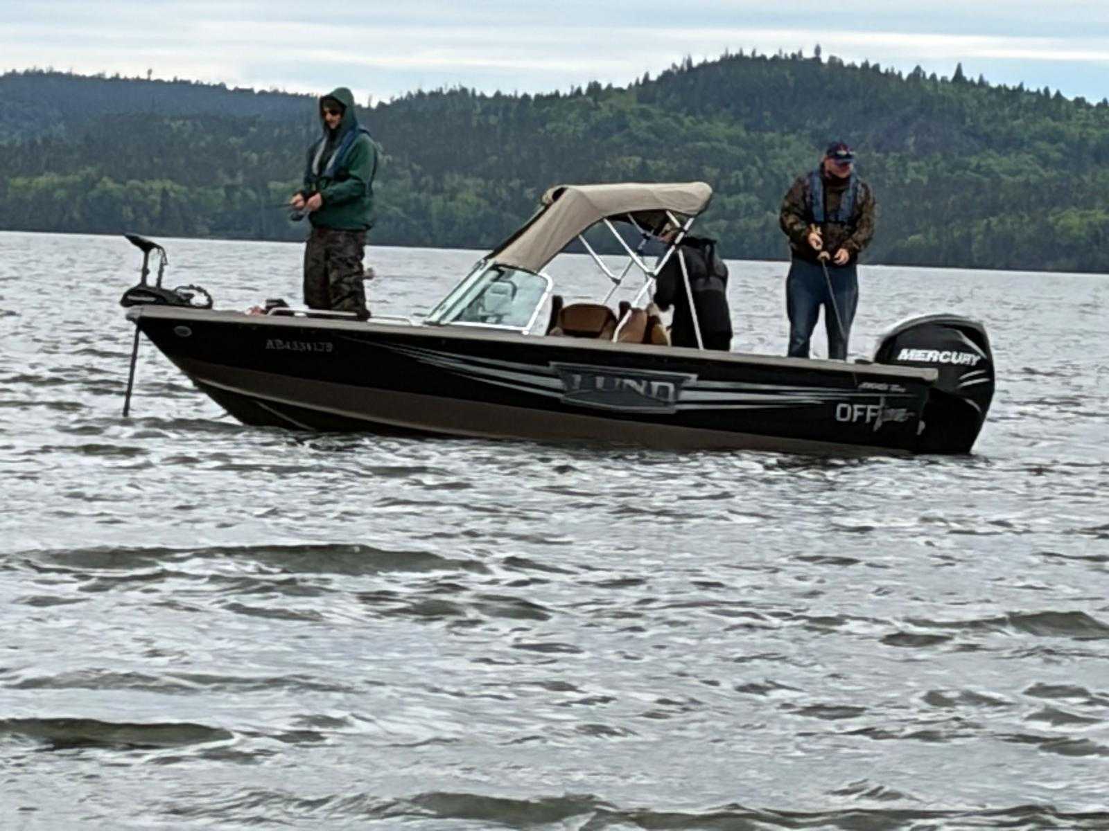 Fishing boat on lake near forested hills in Nipigon Ontario