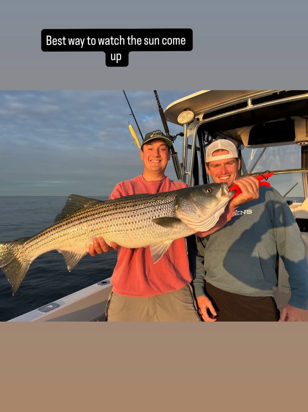 Striped bass fishing charter success in Boston MA waters with fishing boat