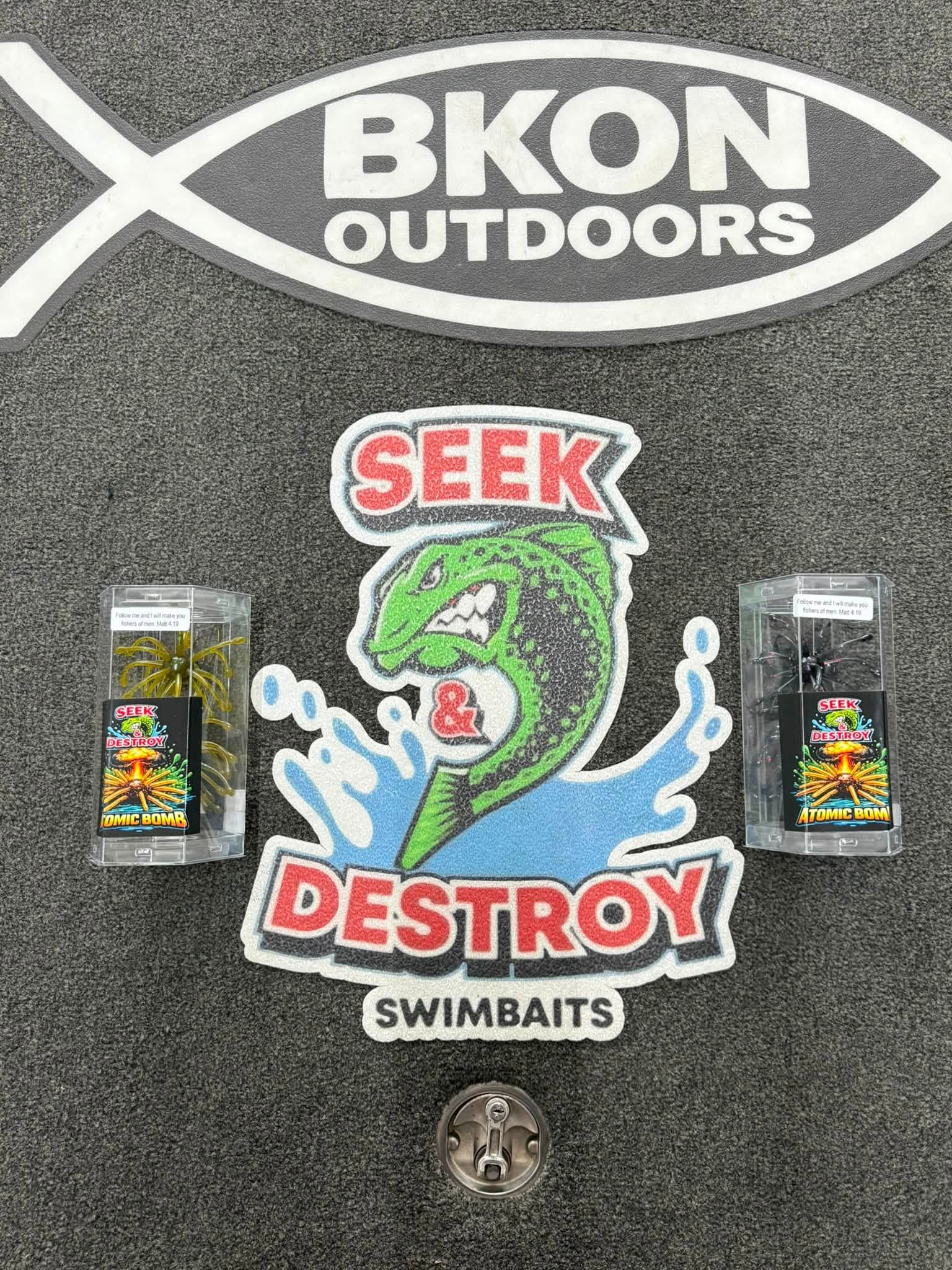 Fishing tackle box displaying BKON Outdoors logo and Seek & Destroy swimbaits with atomic bomb lures