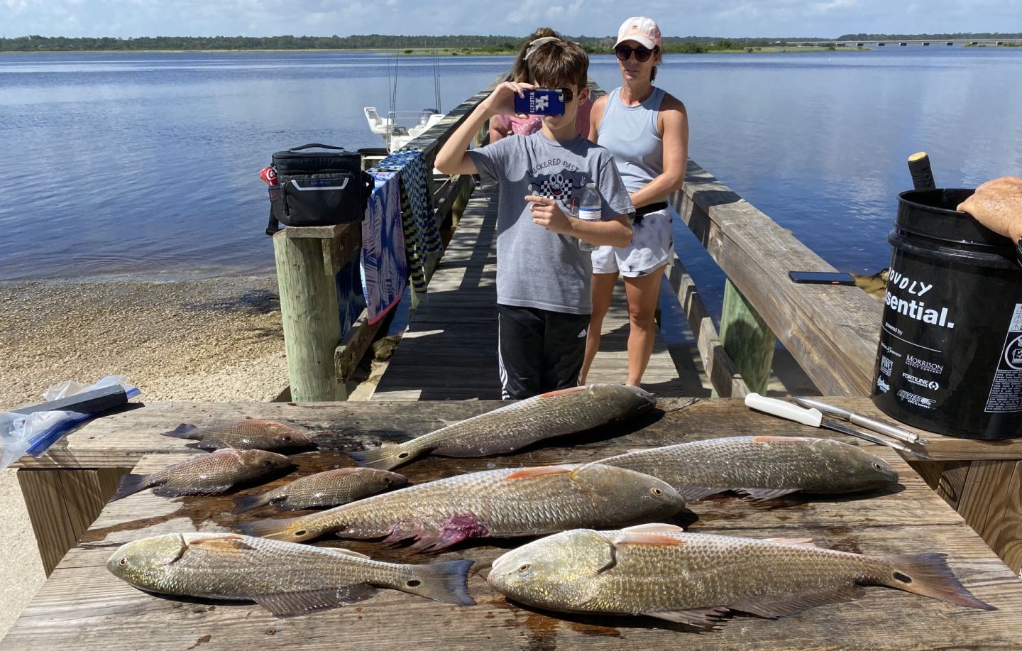Multiple redfish caught during fishing trip in St. Augustine FL displayed on wooden dock