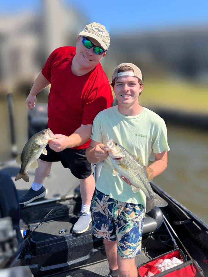 Two anglers displaying freshly caught bass while fishing in Ridgeland MS
