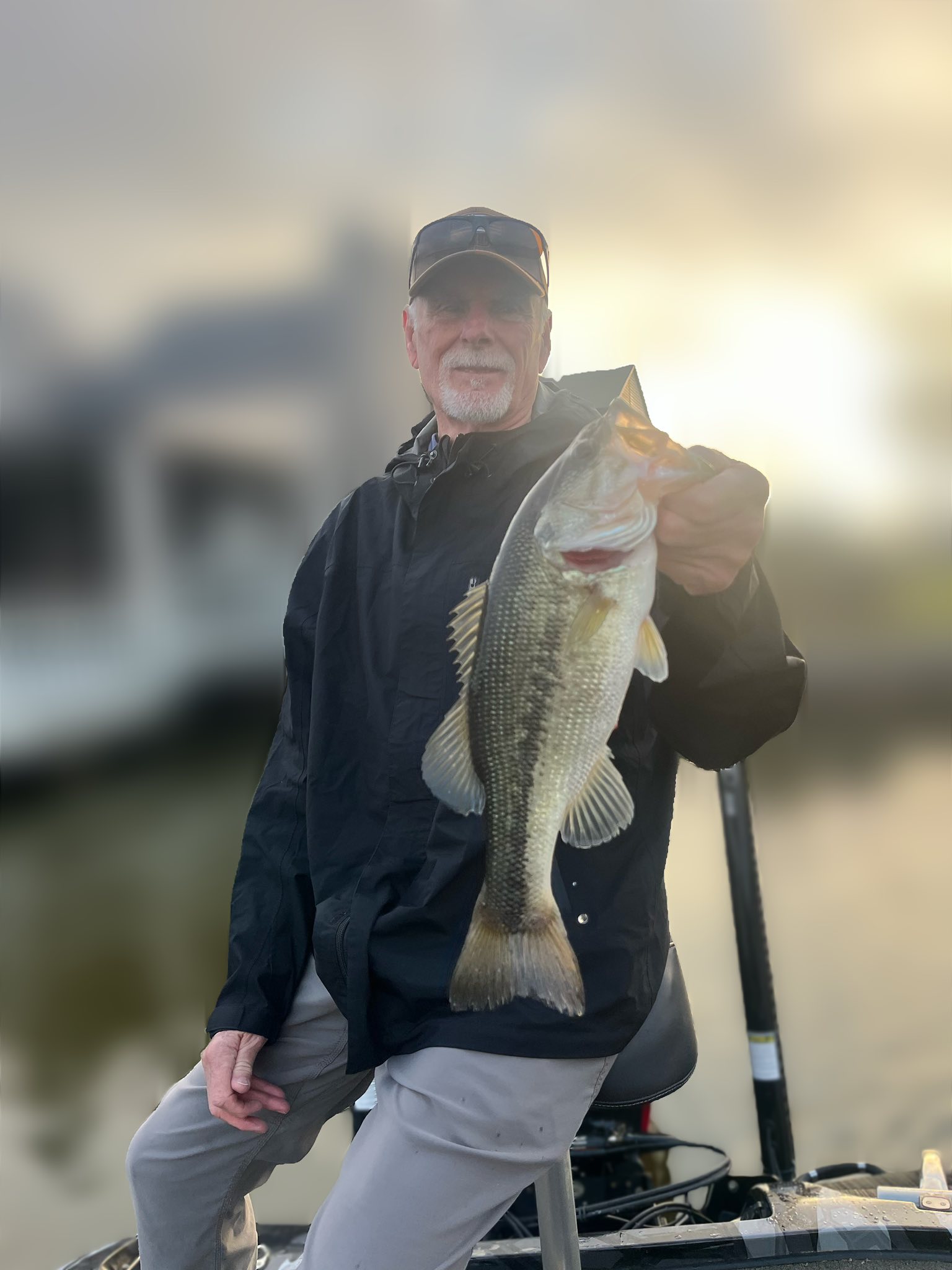Angler holding large bass fish on boat in Ridgeland MS
