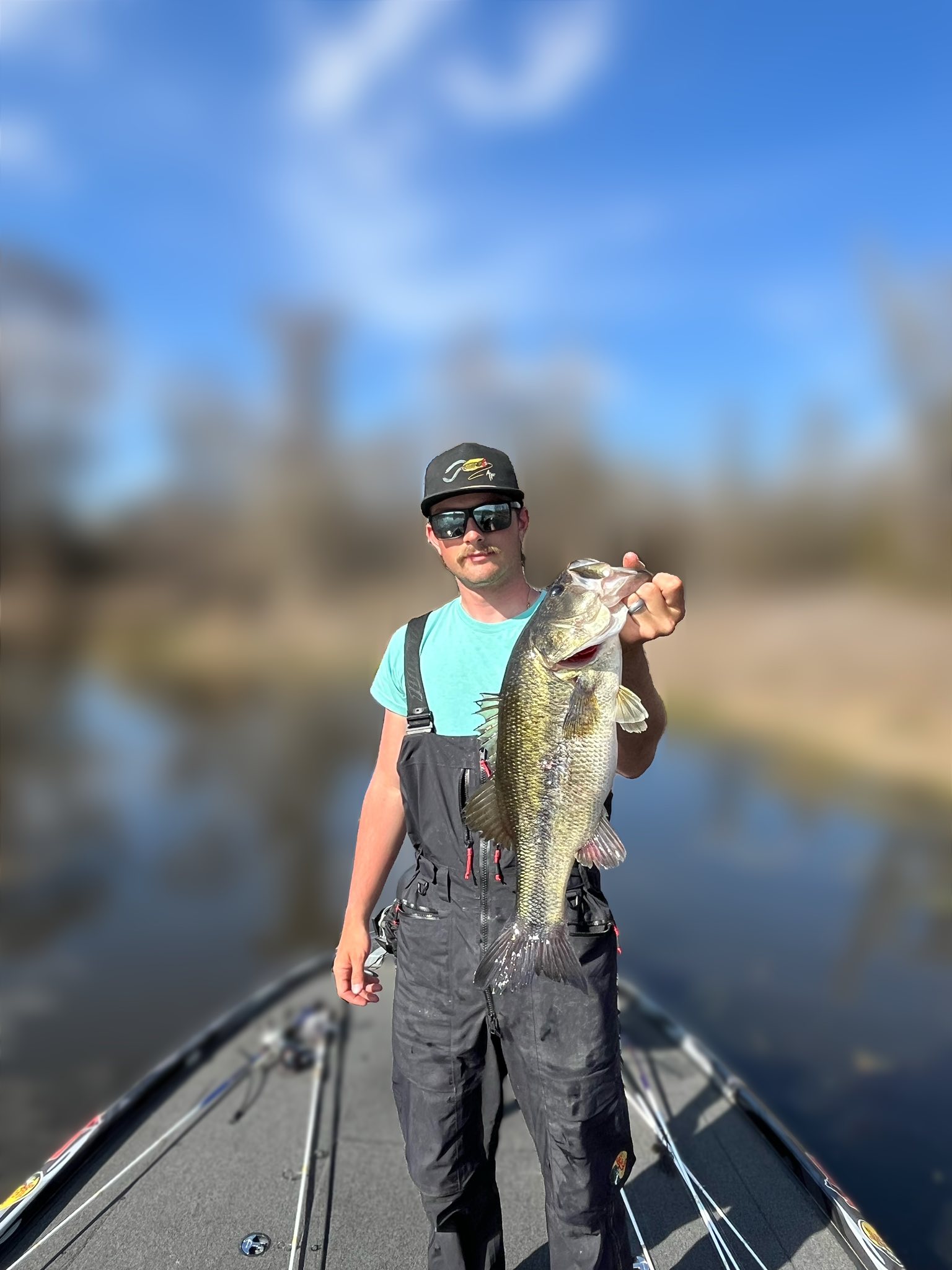 Angler holding large bass fish on boat in Ridgeland MS