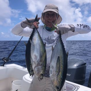 An angler holds 2 decent-sized fish in Florida