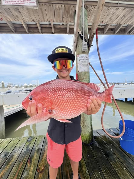 Red snapper caught while fishing in Gulf Shores Alabama displayed on wooden dock