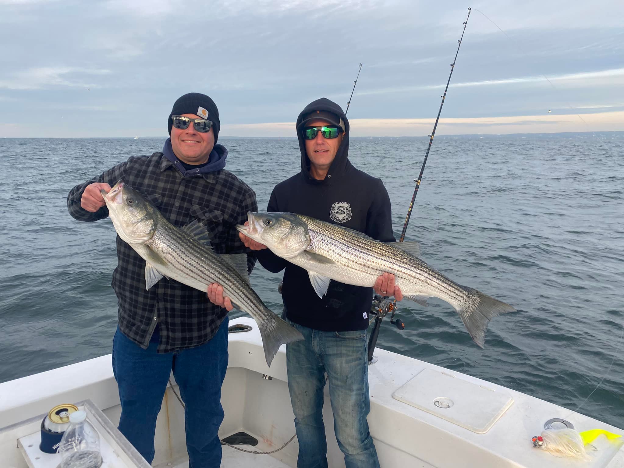 Two striped bass caught by three people in New Jersey