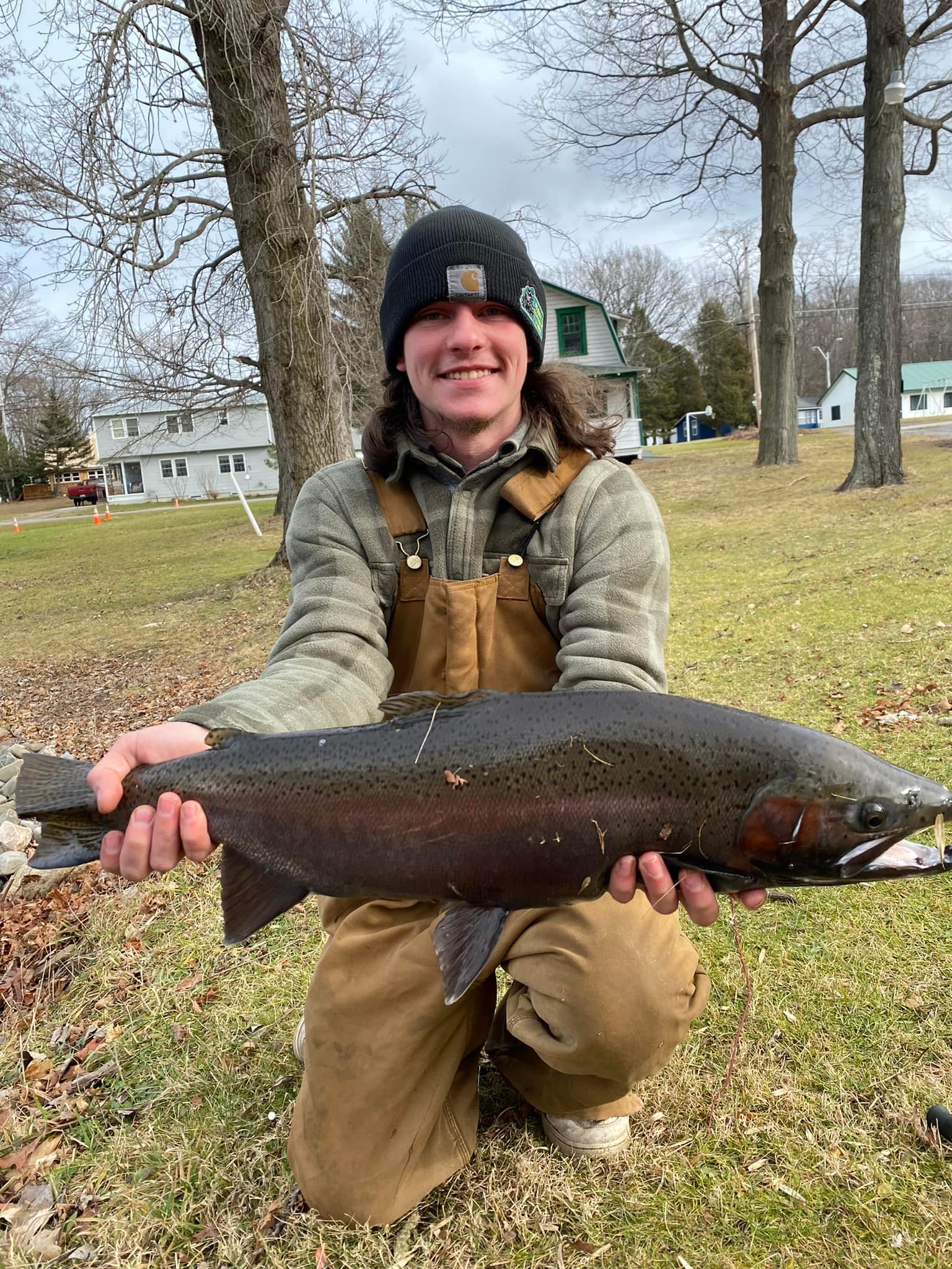 Angler with a rainbow trout caught in Oswego