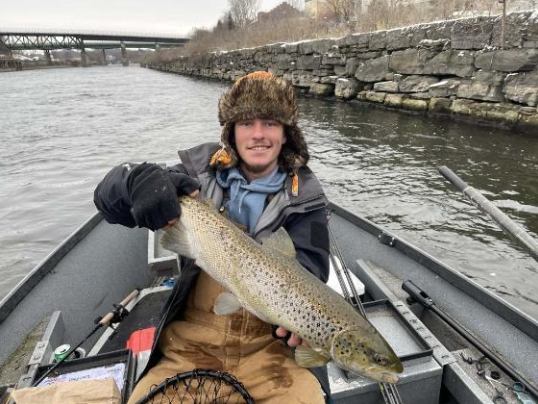 Angler catching a sea trout in Oswego