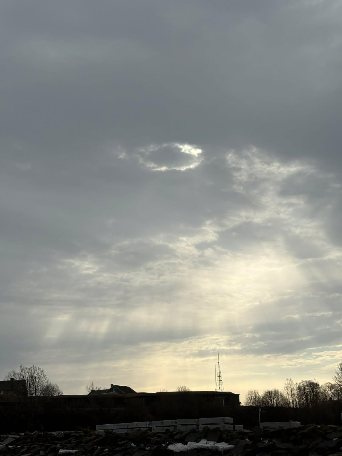Dramatic cloudy sky over waterfront buildings and marina in Oswego NY fishing area