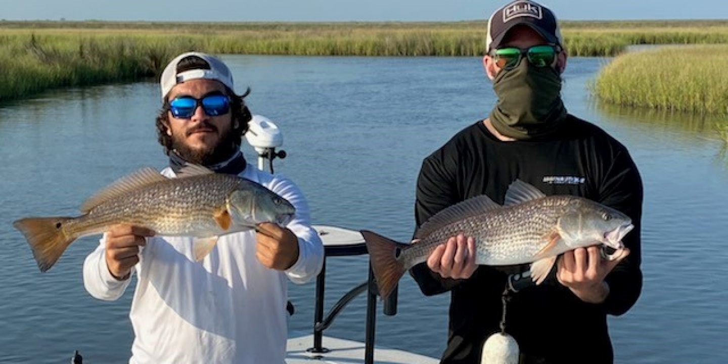 Two redfish caught by two people in Slidell