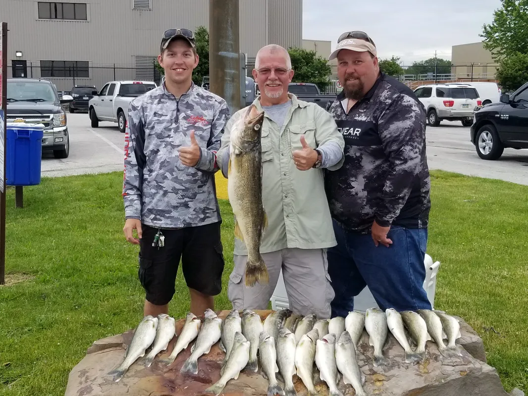 Three people fishing with two big fish in Lorain