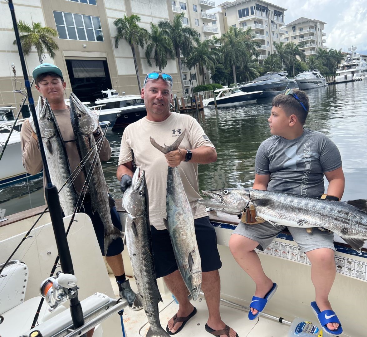 Three king mackerel and great barracuda fish caught while fishing in FL