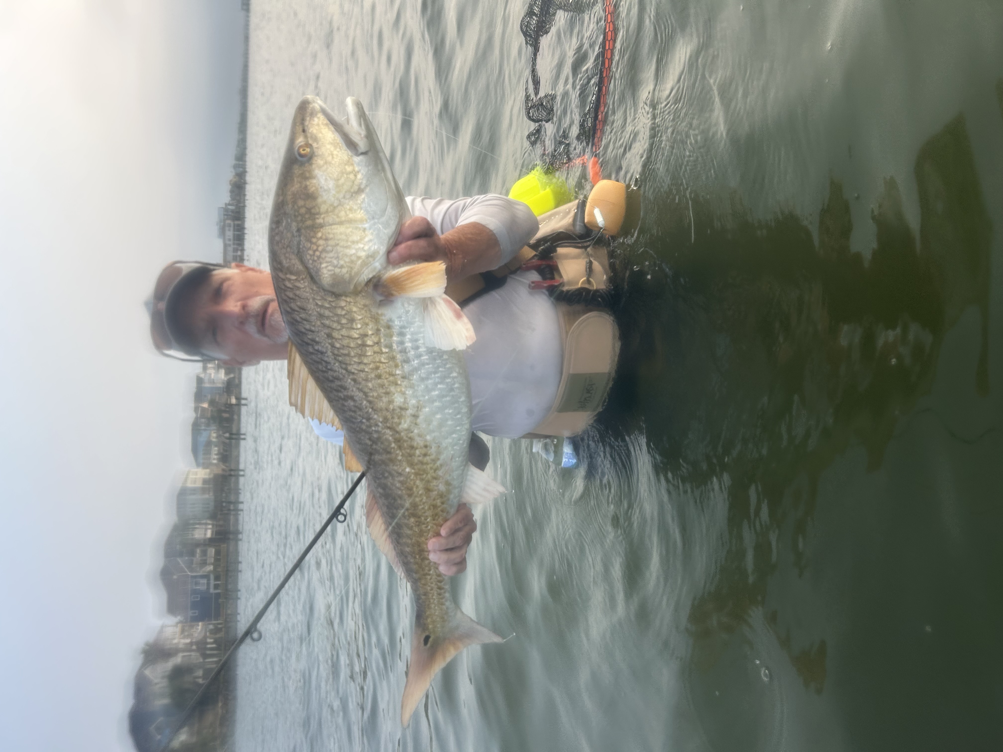 Angler holding large redfish caught in Galveston TX waters