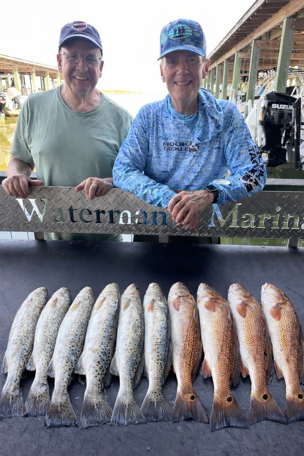Fresh caught redfish and speckled trout displayed on cleaning station at Galveston TX marina