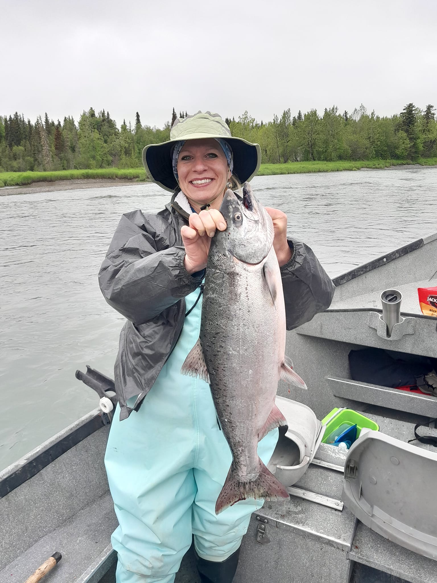 Photograph of a fisherman catching a Chinook Salmon in AK