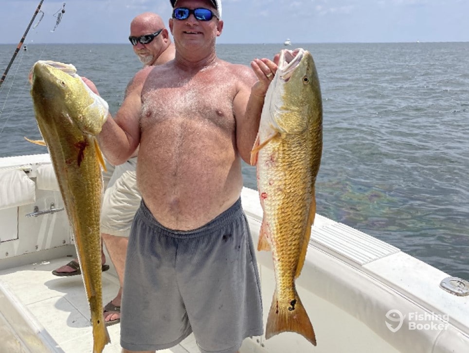 Two people fishing in MS with two big fish