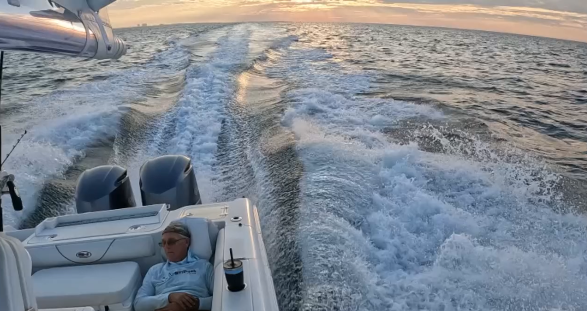 Fishing boat creating wake while traveling across ocean waters near Panama City Beach FL