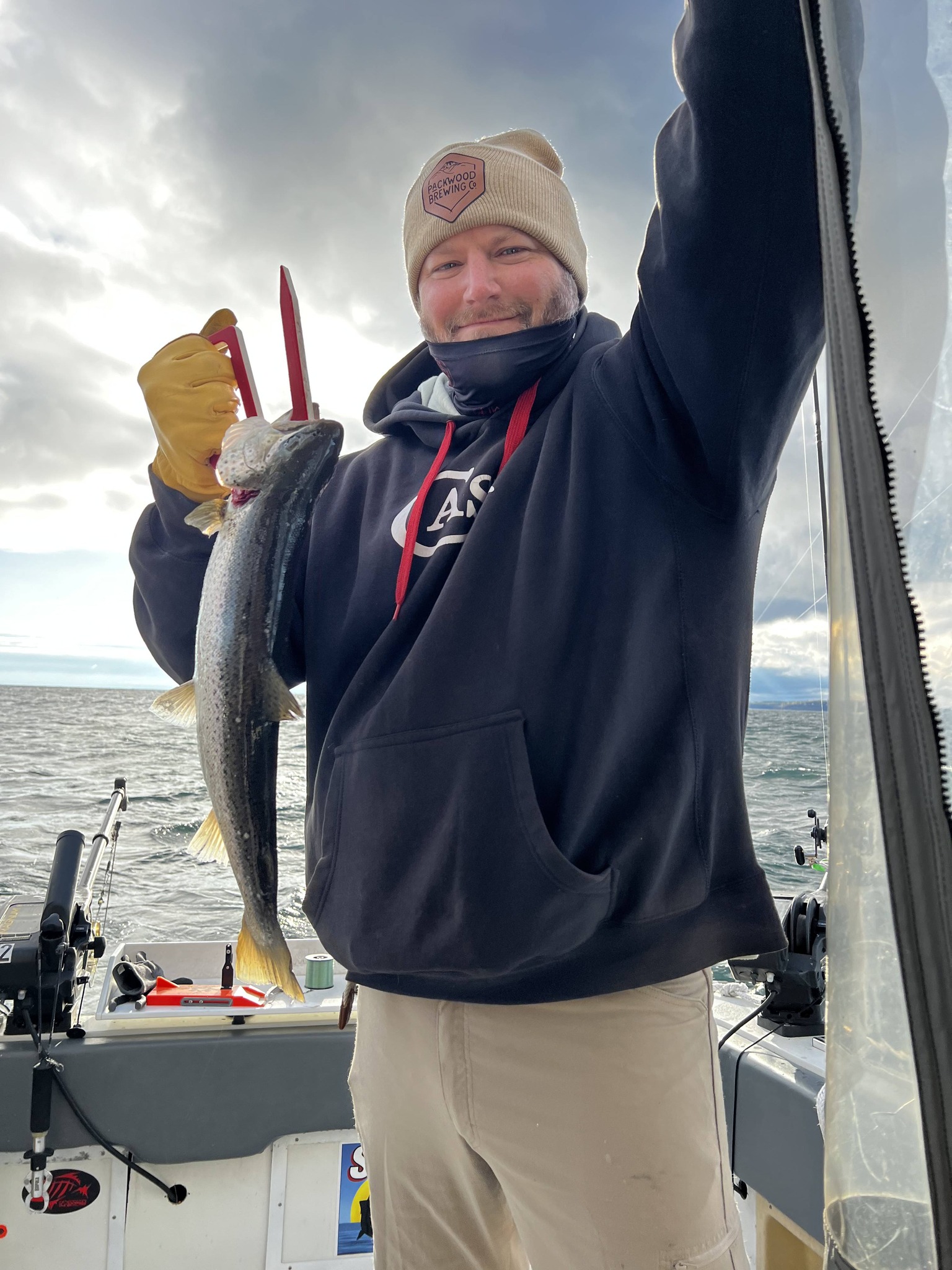 Angler holding freshly caught fish on fishing boat in Sodus Point NY
