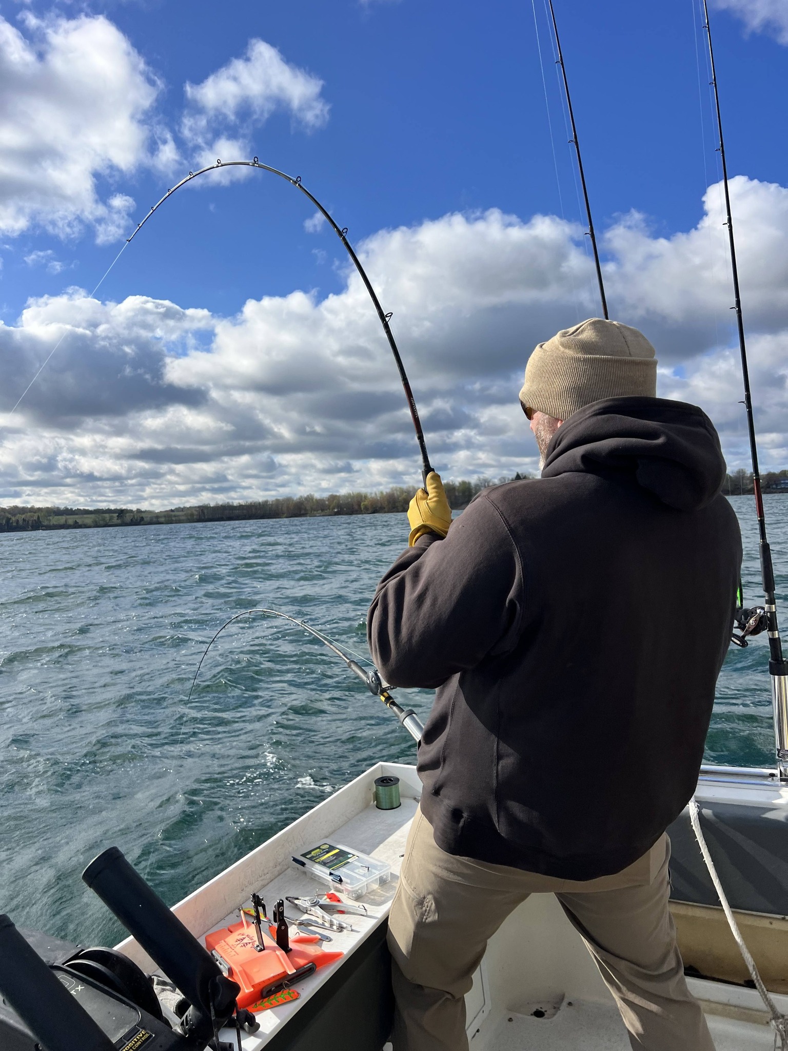 Fishing rod bent with fish on the line from boat on lake in Sodus Point NY