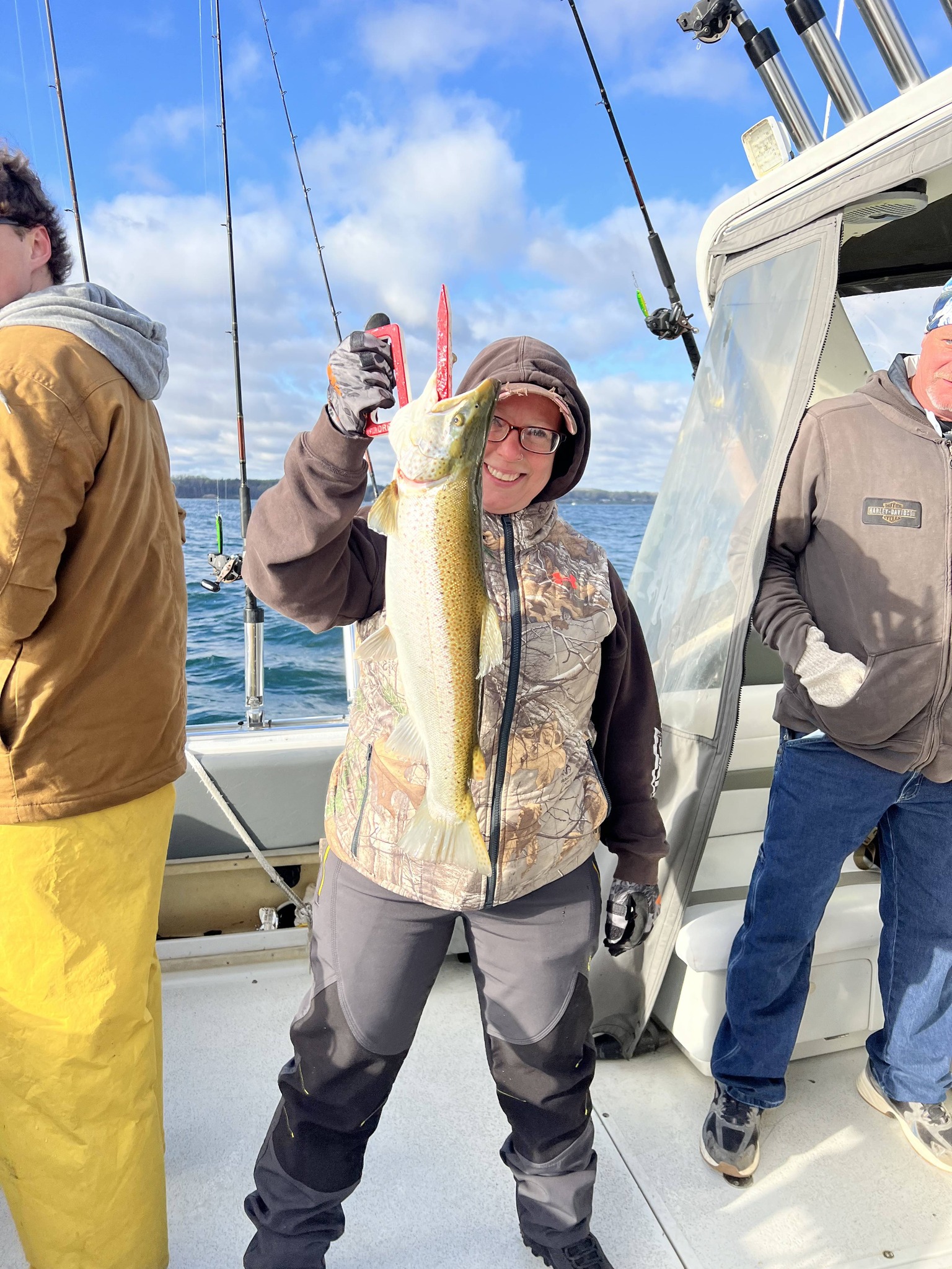 Angler holding caught walleye fish on fishing boat in Sodus Point NY