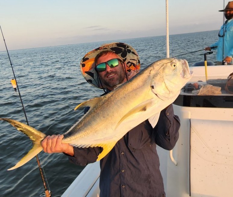 A Crevalle Jack fish caught by two people in Boothville-Venice