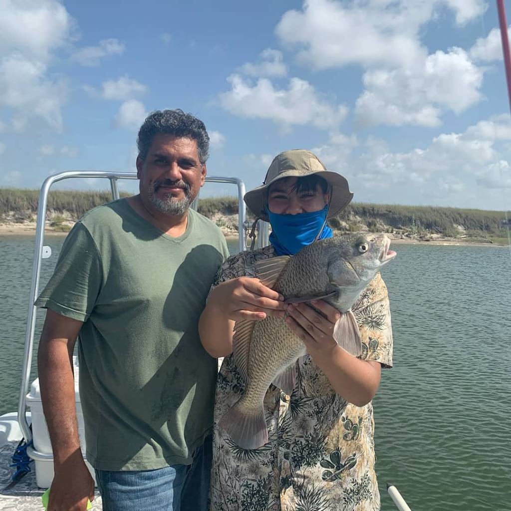 Two people posing for a photo in Corpus Christi