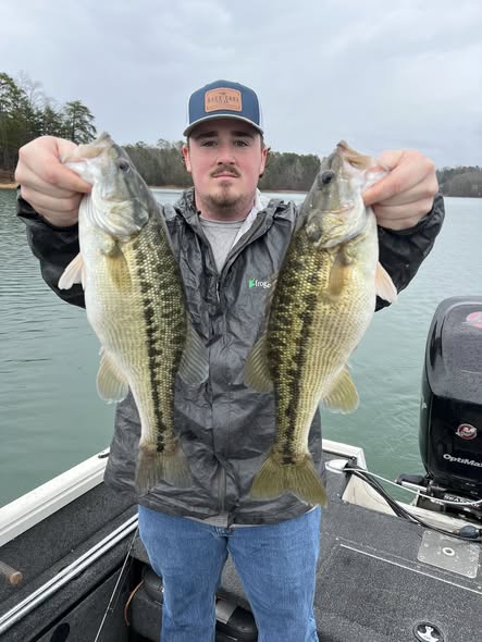 Two spotted bass caught while fishing in Cumming GA displayed on boat