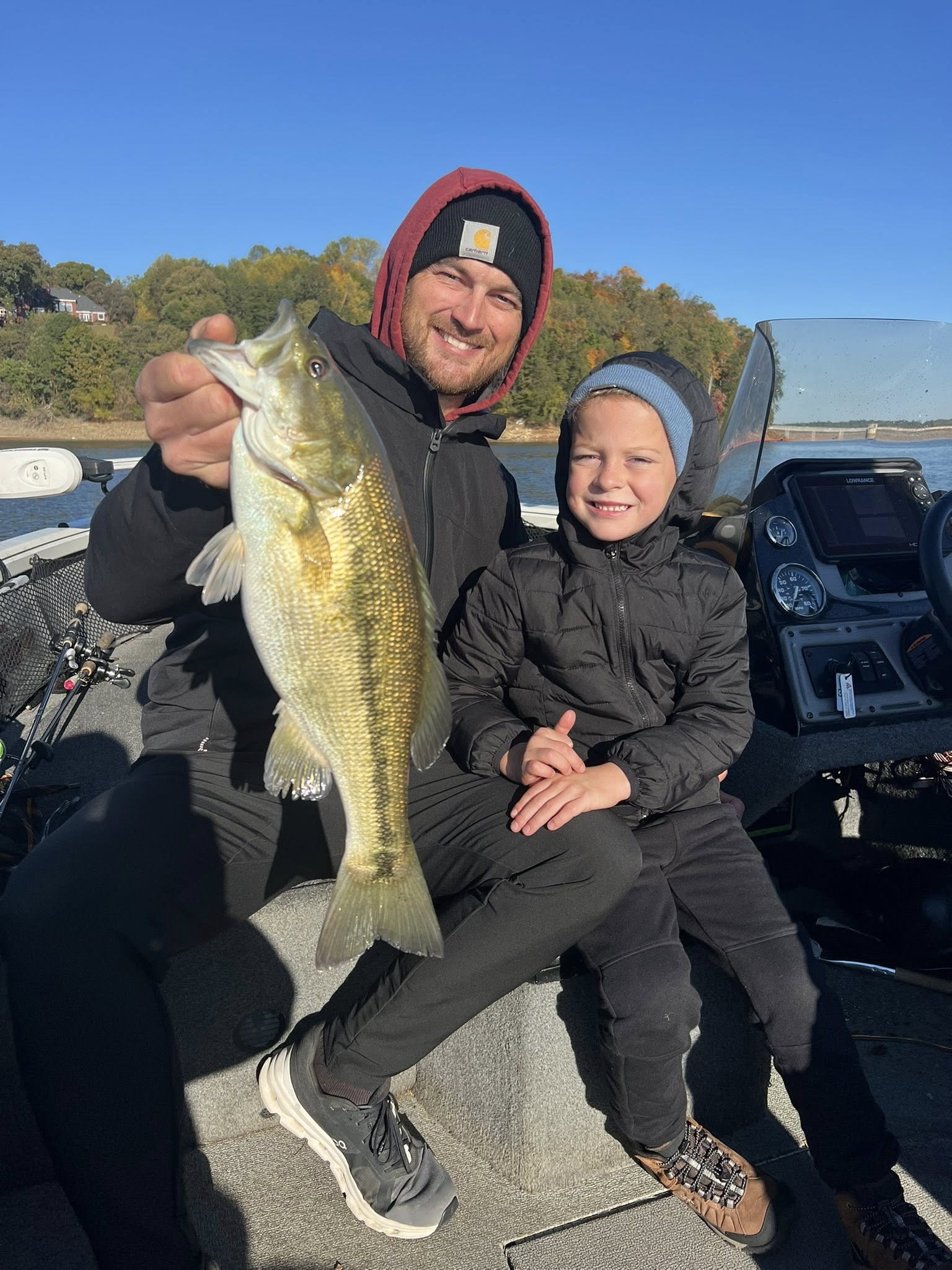 A pair of anglers holding a largemouth bass in Georgia