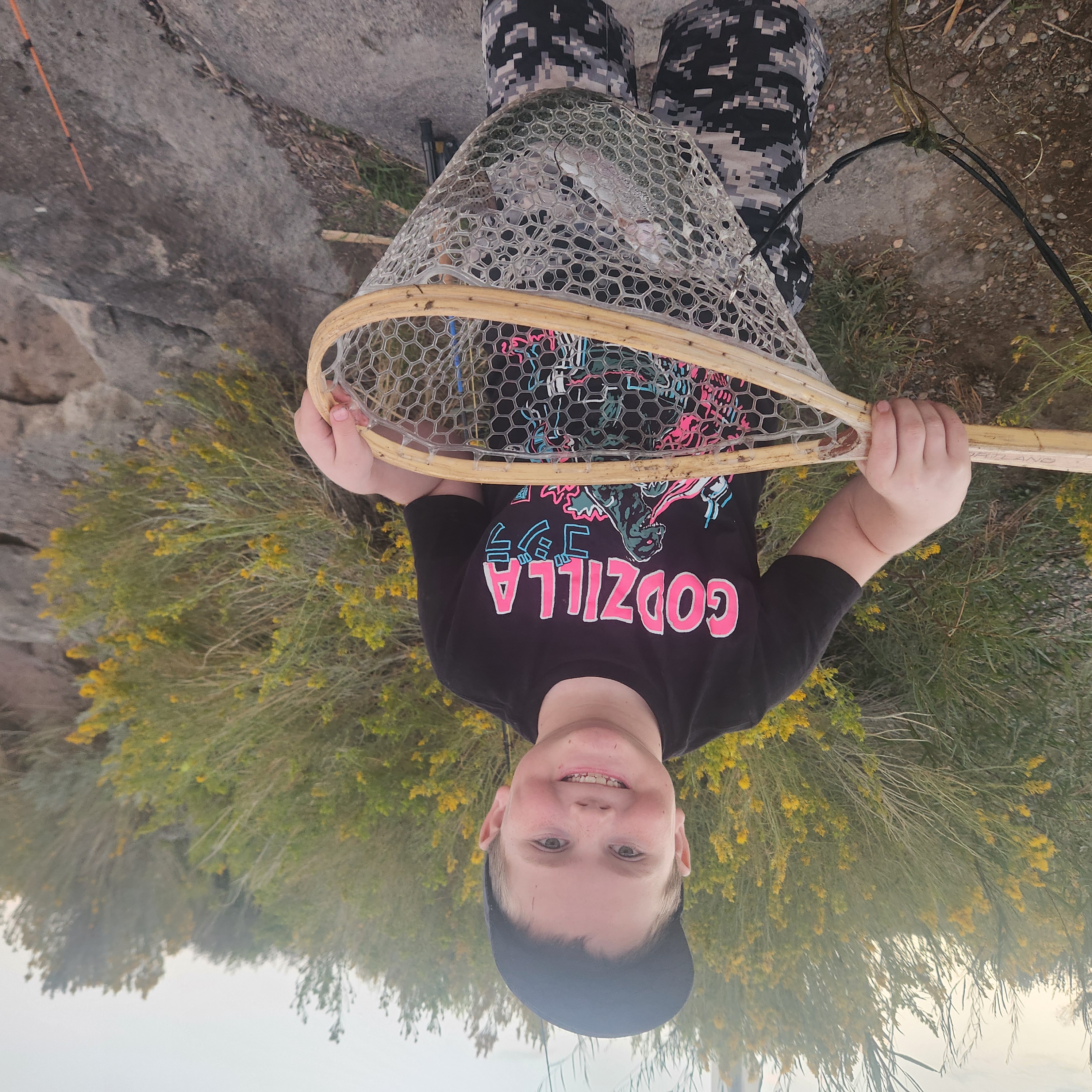 Fishing net with wooden frame held up displaying catch from Panguitch UT fishing tour