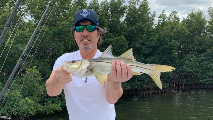 Angler posing with a 20-inch catch in FL