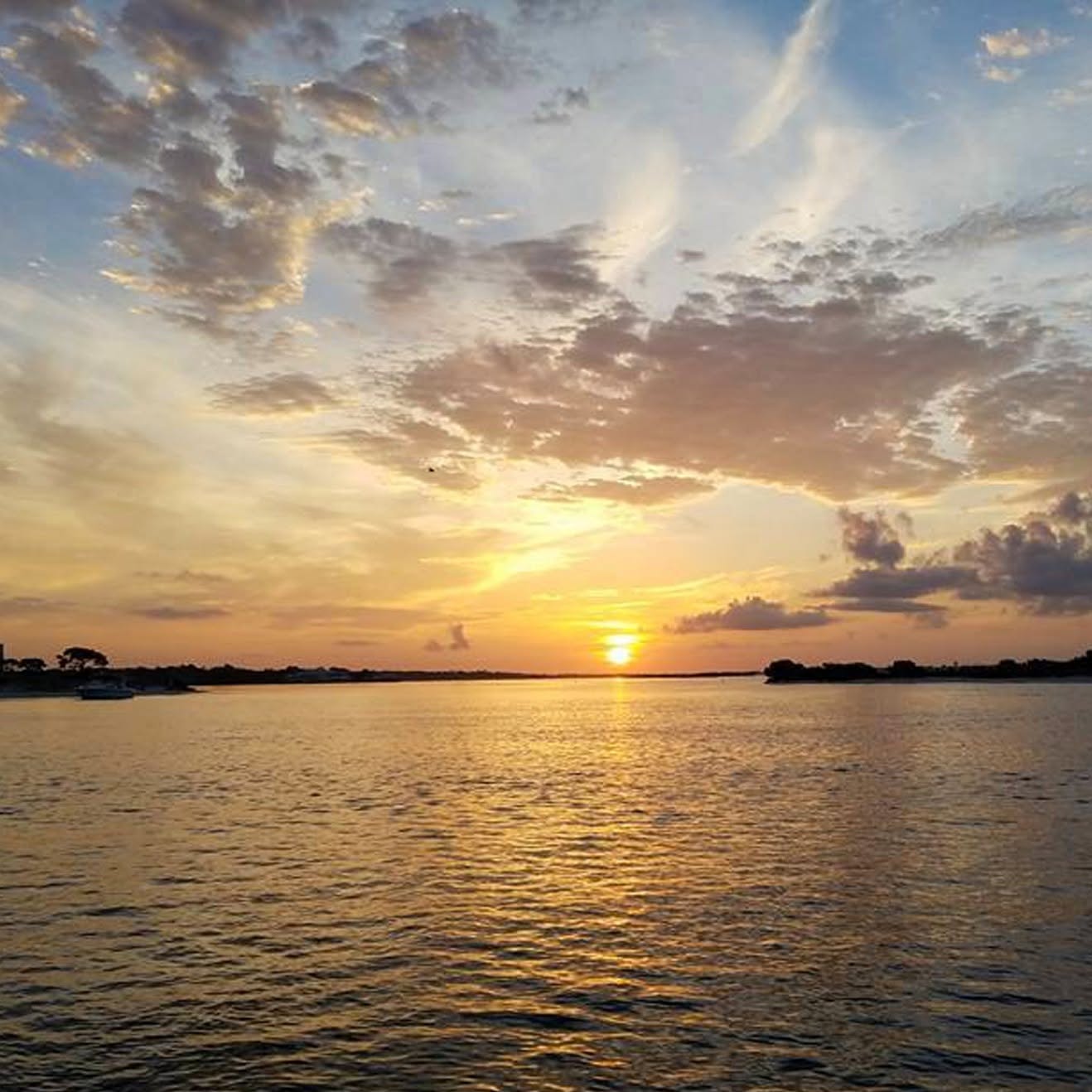 Sunset over calm water in Gulf Shores Alabama during fishing trip