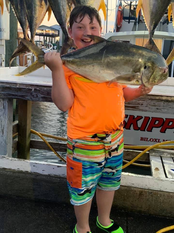 A person fishing in Biloxi with two fish