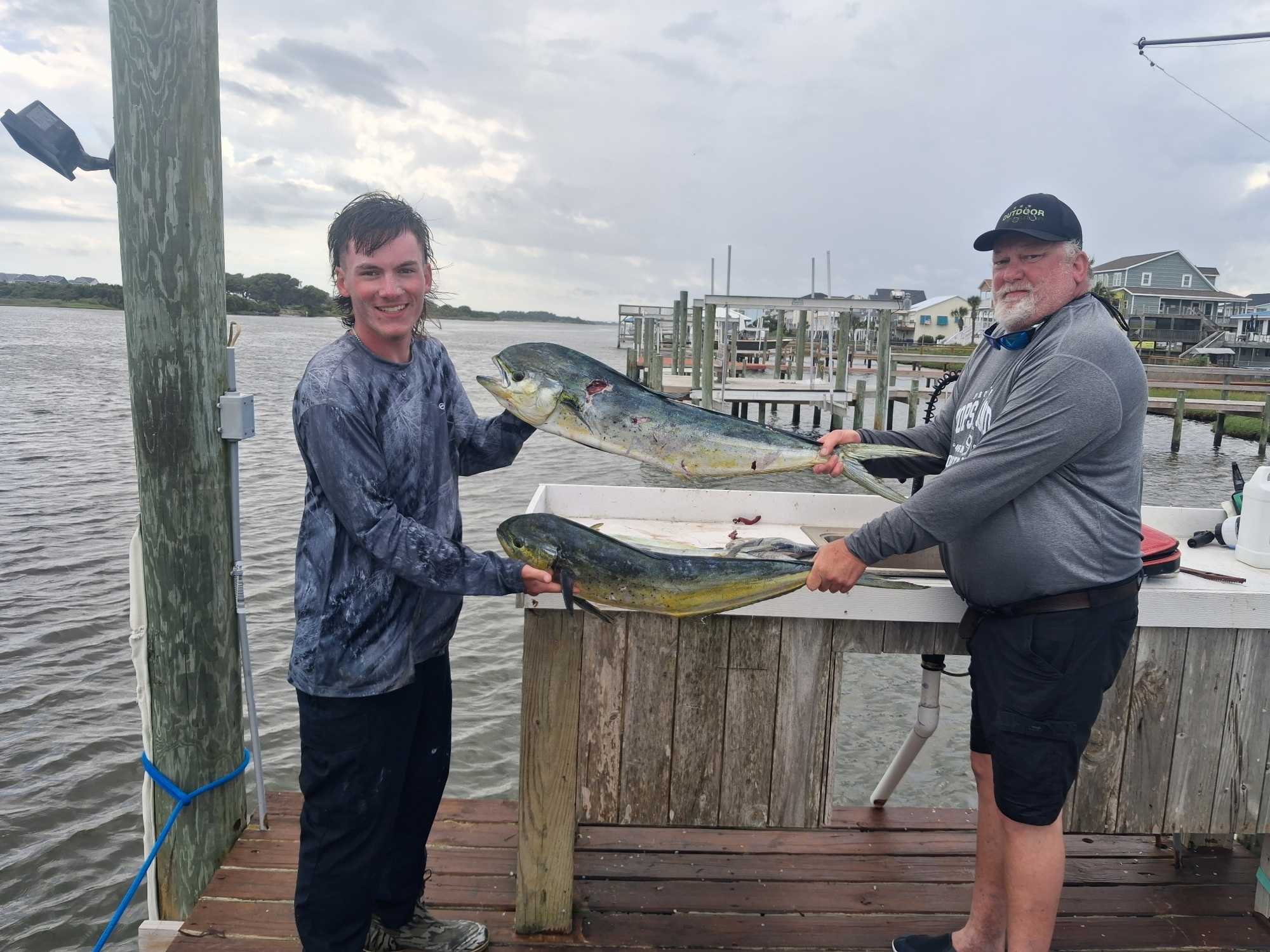 Two fresh Mahi Mahi fish displayed on cleaning station at dock in Sneads Ferry NC