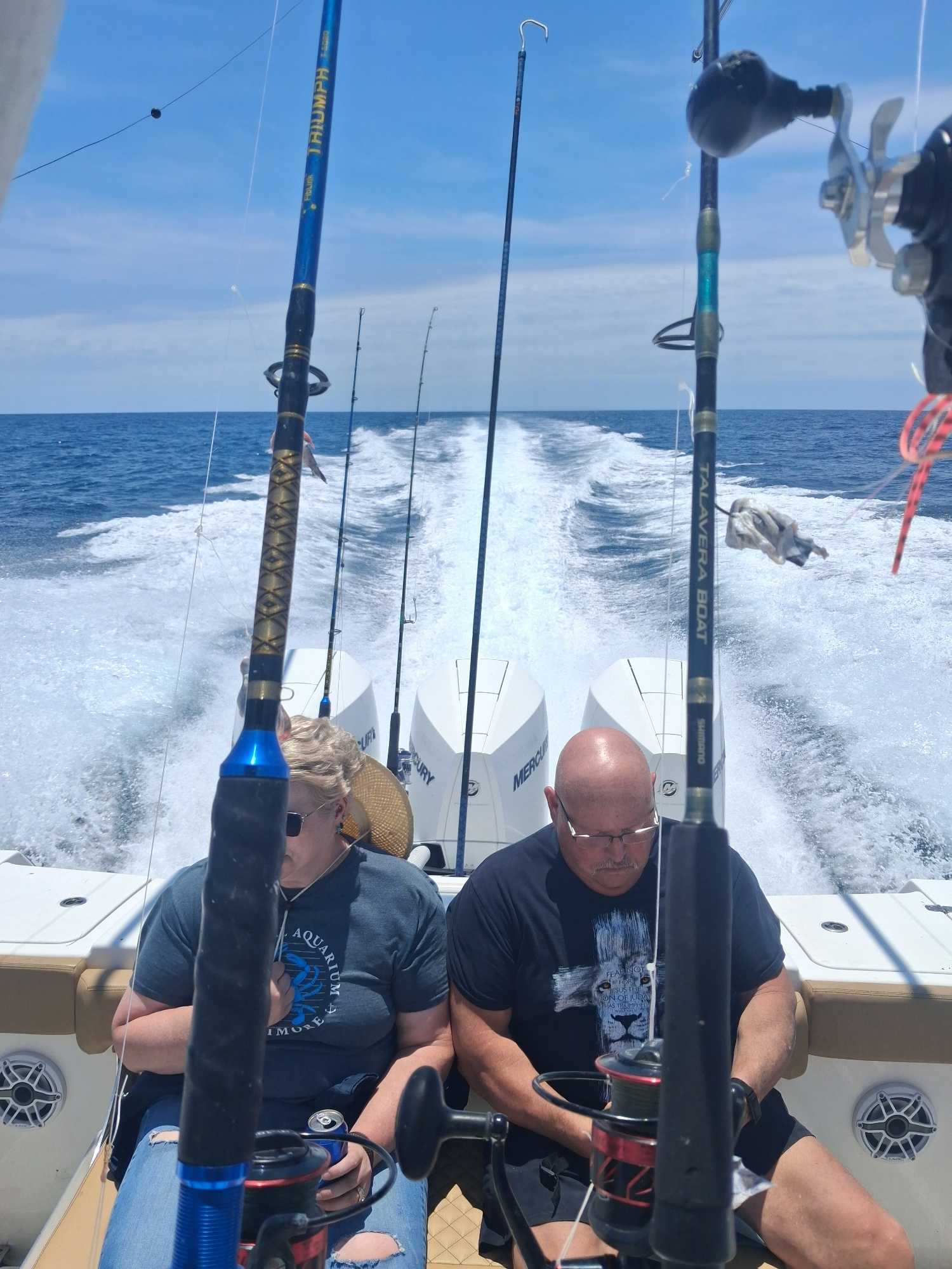 Deep sea fishing boat with multiple fishing rods set up for trolling in Sneads Ferry NC waters