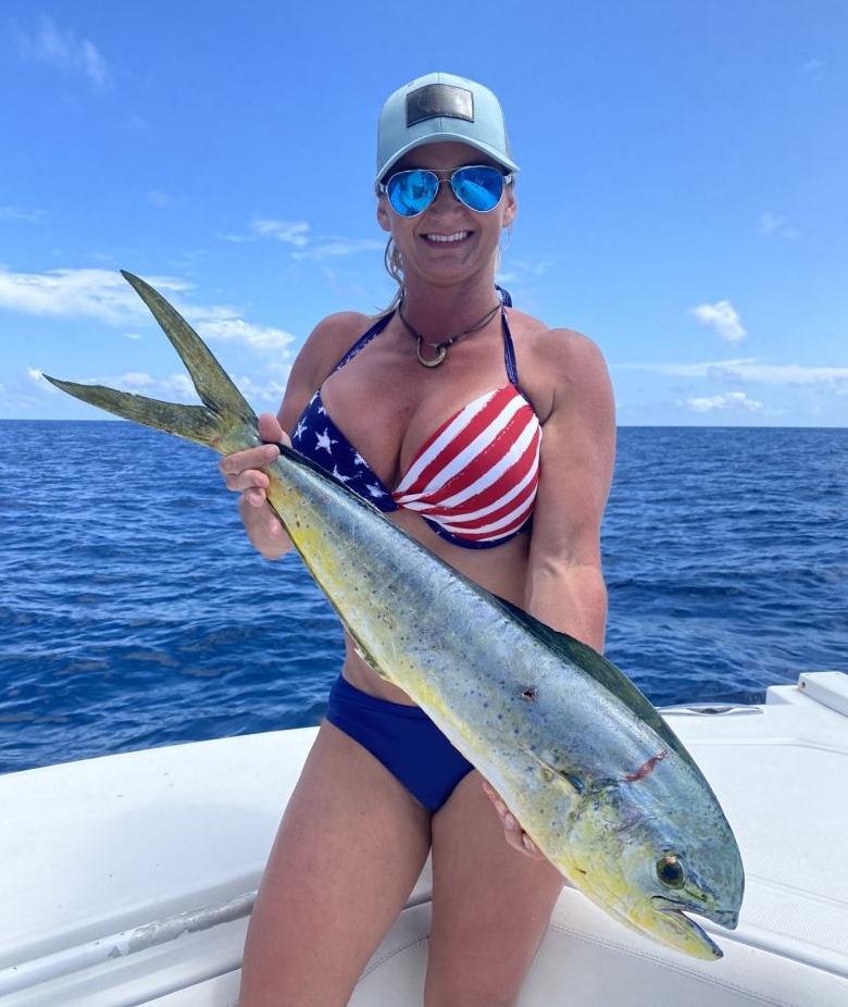 Fisherman standing with a 20-inch catch in Florida