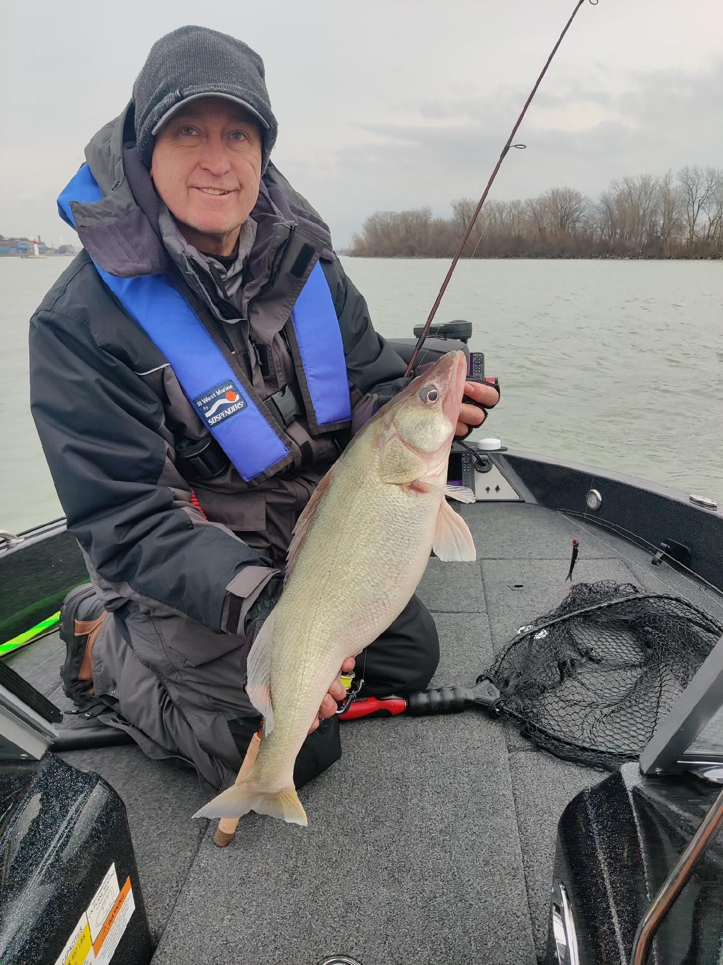 Walleye caught fishing in Delavan WI displayed on boat deck with fishing net