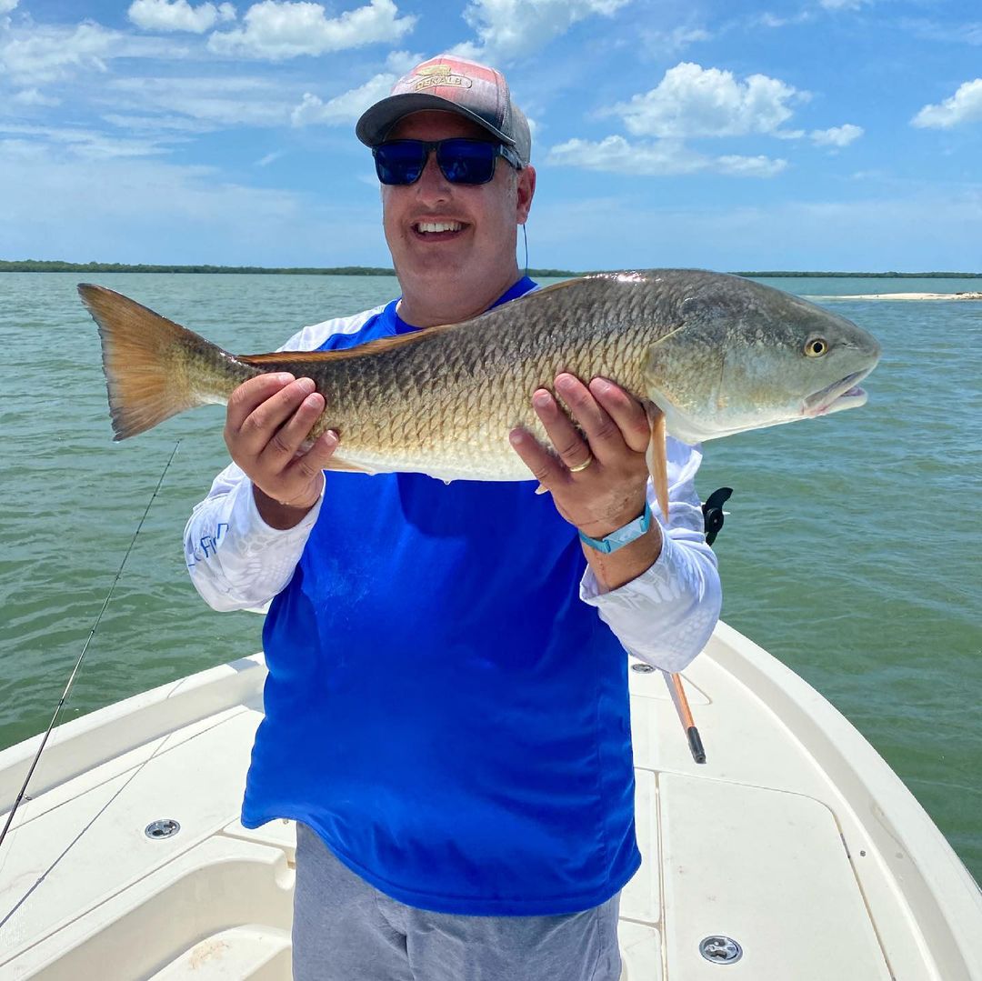 A angler with a large redfish catch in FL