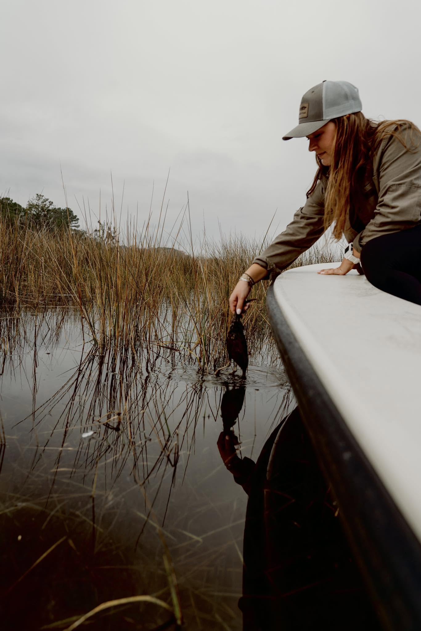 Fishing from boat in marshy waters with tall grass near Johns Island SC